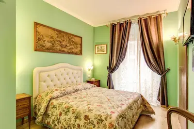 a green bedroom with a bed and a window at La Reggia dei Principi in Rome