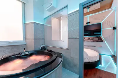 a bathroom with a bath tub and a bed at Hotel Trecento in Rome