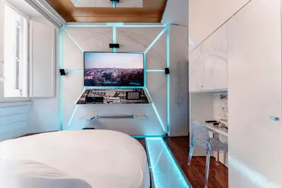 a bedroom with a bed and a desk with a computer at Hotel Trecento in Rome