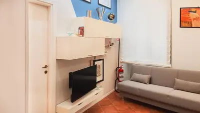 a living room with a couch and a flat screen tv at Domus Chiara al Colosseo in Rome