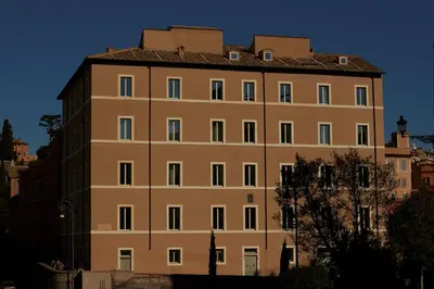 a large tan building with a roof at Palazzo Velabro, a Member of Design Hotels in Rome