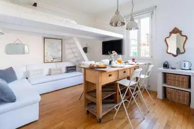 a kitchen and living room with a table and chairs at Cozy Suite Pigneto in Rome