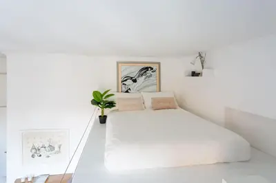 a white bedroom with a large white bed in it at Cozy Suite Pigneto in Rome