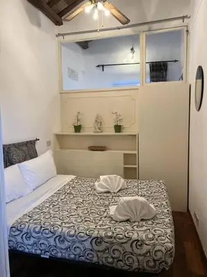 a bedroom with a bed with two pillows on it at A.D. Navona Apartment in Rome