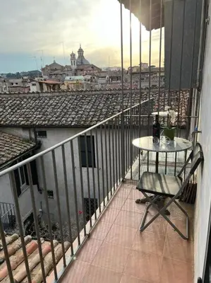 a balcony with a table and a view of a city at A.D. Navona Apartment in Rome