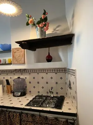 a kitchen with a stove with a pot on a shelf at A.D. Navona Apartment in Rome