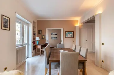 a dining room with a table and chairs at GuestHost - MM Cipro Elegant Apartment in Rome