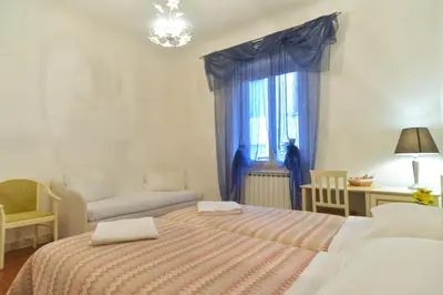 a bedroom with two beds and a window at Gisa Rooms in Rome