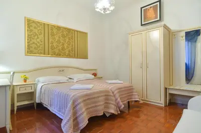 a bedroom with a bed with two towels on it at Gisa Rooms in Rome