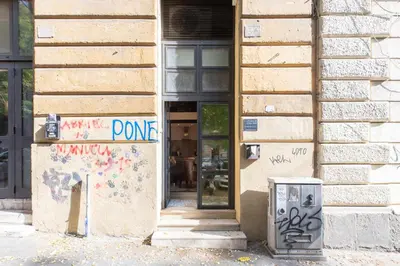 a store with graffiti on the side of a building at iFlat Trastevere Unique Loft in Rome