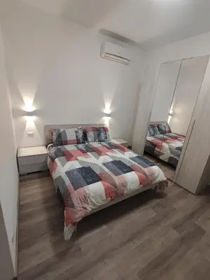 a bedroom with a bed and a mirror in it at Lotto 30 Metro Garbatella in Rome