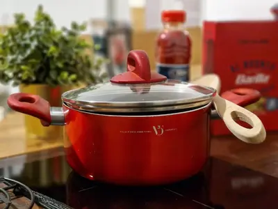a red pot with a lid on a stove at Giuditta San Pietro 52 Loft Roma in Rome