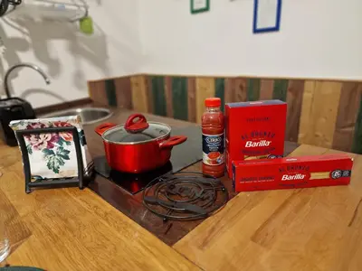 a stove with a pot and a book on a table at Giuditta San Pietro 52 Loft Roma in Rome