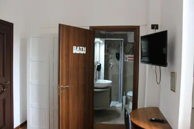 a bathroom with a toilet and a door that says faith at Rooms Piramide in Rome