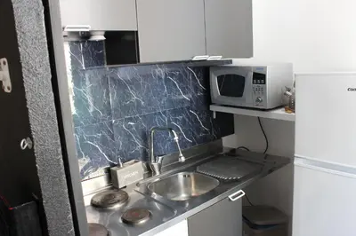 a small kitchen with a sink and a microwave at Rooms Piramide in Rome