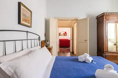 a bedroom with a bed with two towels on it at CHARMING APARTMENT AT SPANISH STEPS, no elevator in Rome