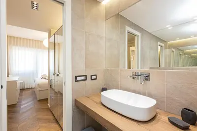 a bathroom with a white sink and a mirror at AURELIA SUNSET PENTHOUSE by Rental in Rome in Rome
