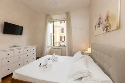 a bedroom with a white bed and a window at SAINT PETER HOME by Rental in Rome in Rome