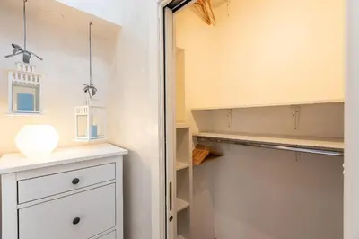 a walk in closet with white cabinets and a shelf at SAINT PETER HOME by Rental in Rome in Rome