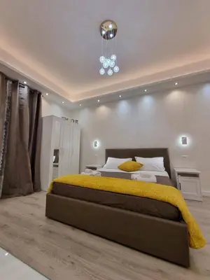 a bedroom with a large bed and a chandelier at Apartment near the Colosseum, with metro line A a 2 minutes walk away in Rome