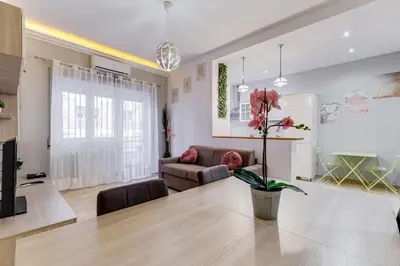 a living room with a table and a couch at JMartins Vatican suites in Rome