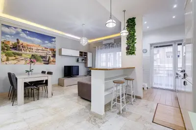 a kitchen and dining room with a table and chairs at JMartins Vatican suites in Rome