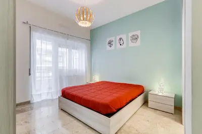 a bedroom with a bed with a red blanket at JMartins Vatican suites in Rome