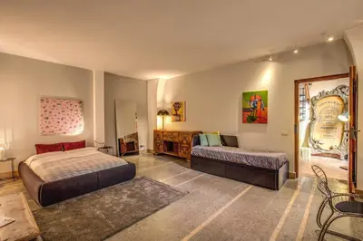 a bedroom with two beds and a couch in it at The Smart Loft in Rome