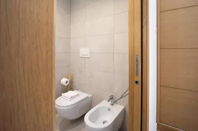a bathroom with a toilet and a sink at Casa Camilla in Rome