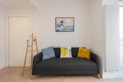 a couch in a living room with a painting on the wall at Casa Camilla in Rome