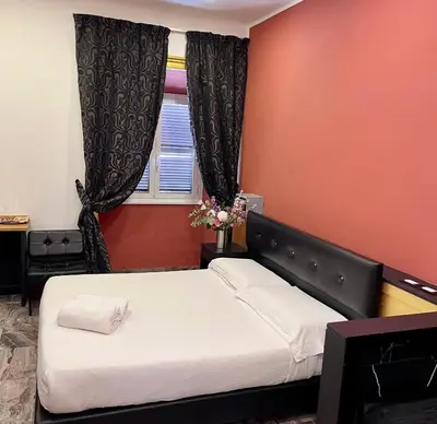 a bedroom with two beds and a window at The Cicer One in Rome