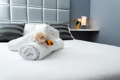 a pile of towels sitting on top of a bed at The Cicer One in Rome