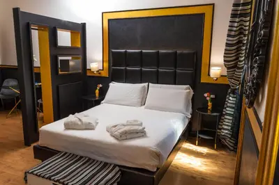 a bedroom with a bed with towels on it at The Cicer One in Rome