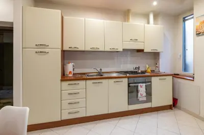 a kitchen with white cabinets and a sink at Pigneto Vannini Roma in Rome