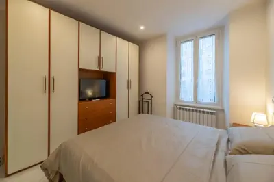 a bedroom with a large bed and a tv at Pigneto Vannini Roma in Rome