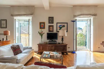 a living room with a couch and a tv at Colosseum - Charme Holidays in Rome