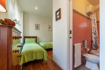 a bedroom with a bed and a bathroom with a sink at Colosseum - Charme Holidays in Rome