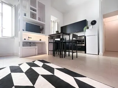 a kitchen with a black and white checkered floor at Domus Colosseum by JFM - Cozy apartment nearby Colosseum in Rome