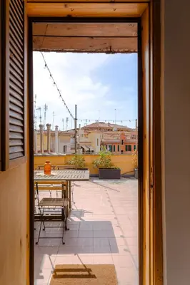 a view from a door of a patio with a table at La mansarda del Papa - ZENO 05 in Rome