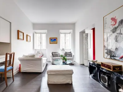 a living room with white furniture and a table at Apartment San Salvatore by Interhome in Rome