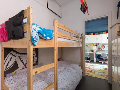 a bedroom with two bunk beds and a desk at Apartment San Salvatore by Interhome in Rome