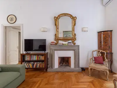 a living room with a fireplace and a mirror at Apartment Virgilio by Interhome in Rome