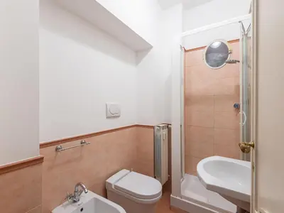 a bathroom with a toilet and a sink and a shower at Apartment Virgilio by Interhome in Rome