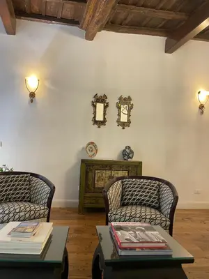 a living room with two chairs and a table at Residenza Clodio Spanish Steps in Rome