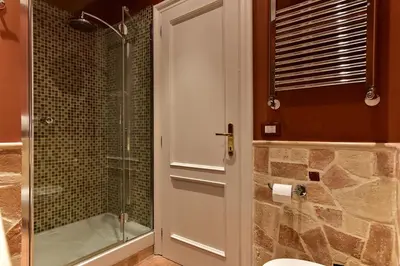 a bathroom with a shower and a toilet and a glass door at Residenza Clodio Spanish Steps in Rome