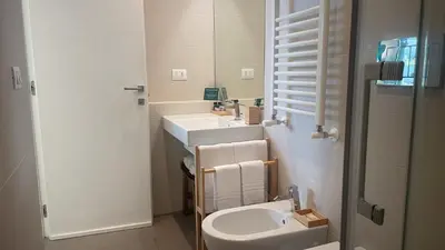 a bathroom with a sink and a toilet and a mirror at GreenSpace Romantic Studio - Piazza del Popolo in Rome