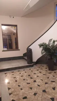 a room with a staircase with a mirror and a potted plant at Lovely Suite accogliente appartamento tra Policlinico e Piazza Bologna in Rome