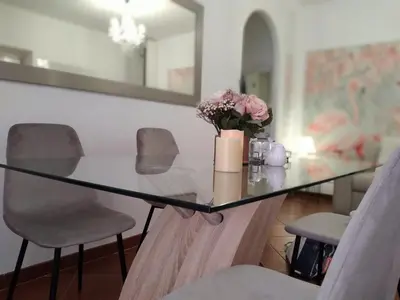 a glass table with a vase of flowers on it at Casina Tiberina Suite in Rome