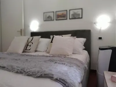 a bedroom with a bed with white pillows at Casina Tiberina Suite in Rome