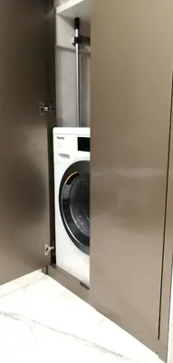 a washer and dryer sitting inside of a kitchen at Trastevere Boutique with Gym and Steam Shower in Rome